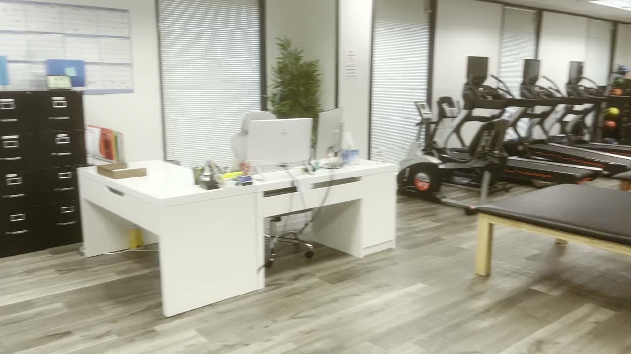 The front office desk at our clinic, with filing cabinets and the posting board behind it