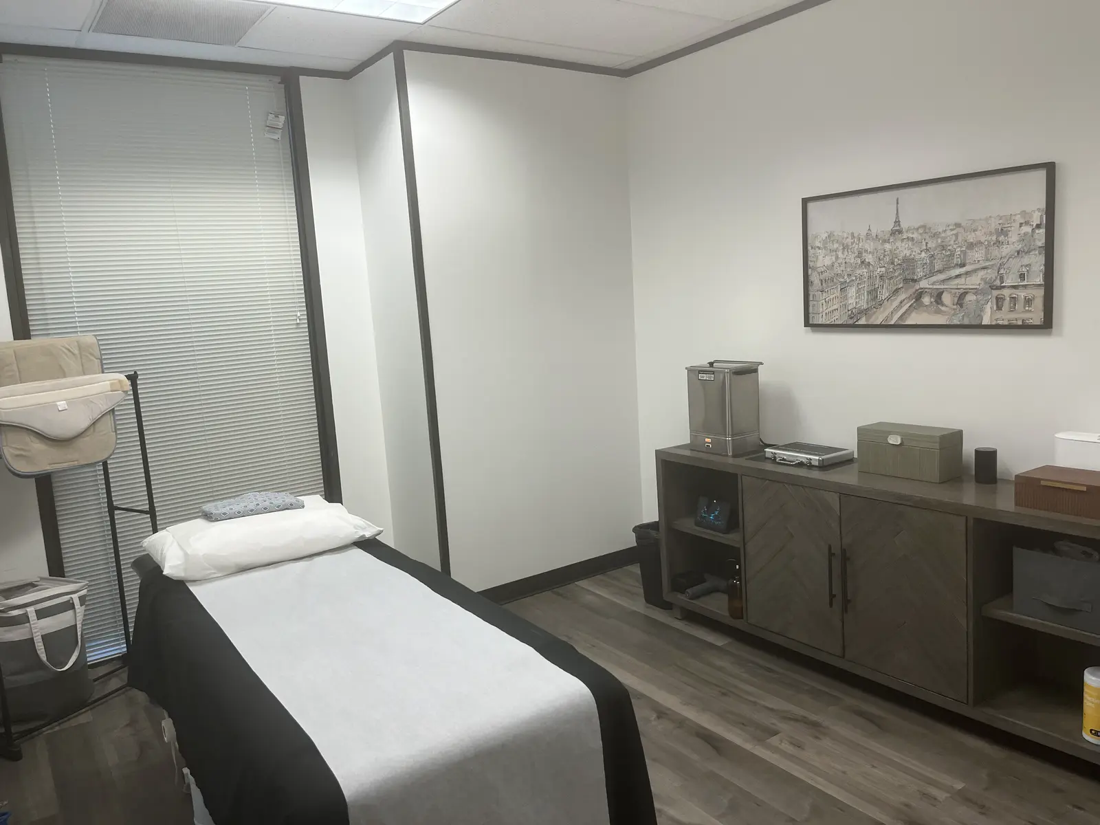 A private treatment room with the table made up and supplies on the dresser